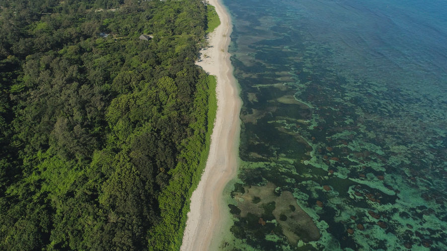 Aerial view of seashore with beach, lagoons and coral reefs. ocean coastline with turquoise water. 