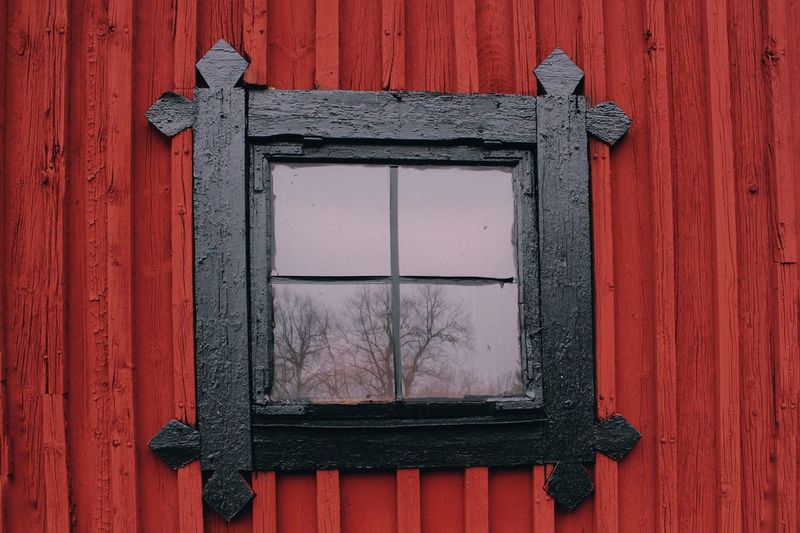 Close-up of window on red door