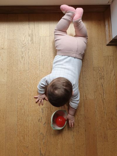 High angle view of boy lying on floor at home