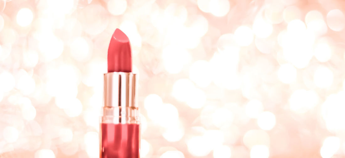 Close-up of red lipstick against illuminated light