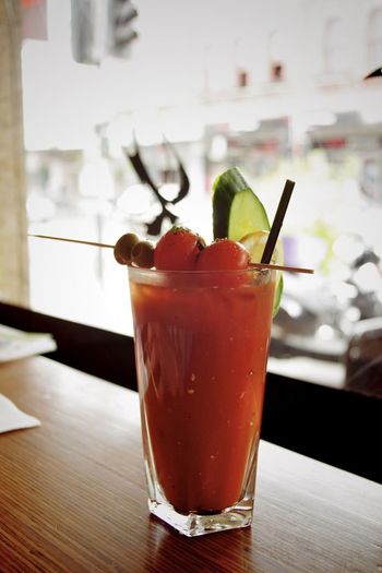 Close-up of bloody mary cocktail served on bar counter