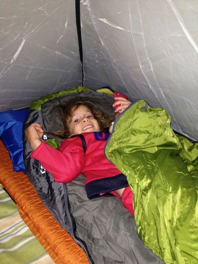 High angle portrait of girl lying on tentfloor