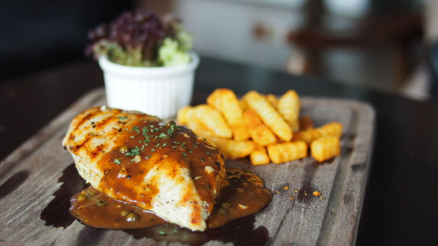 Close-up of chicken steak with fries