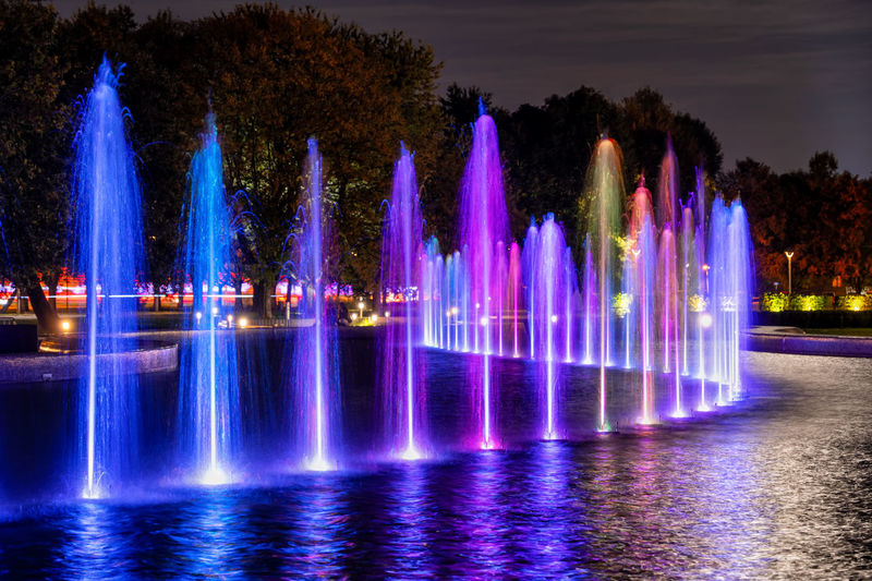 Illuminated fountain against sky at night