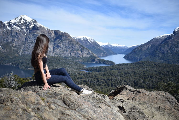 Woman sitting on mountain