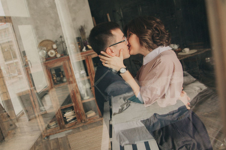 Couple kissing in window