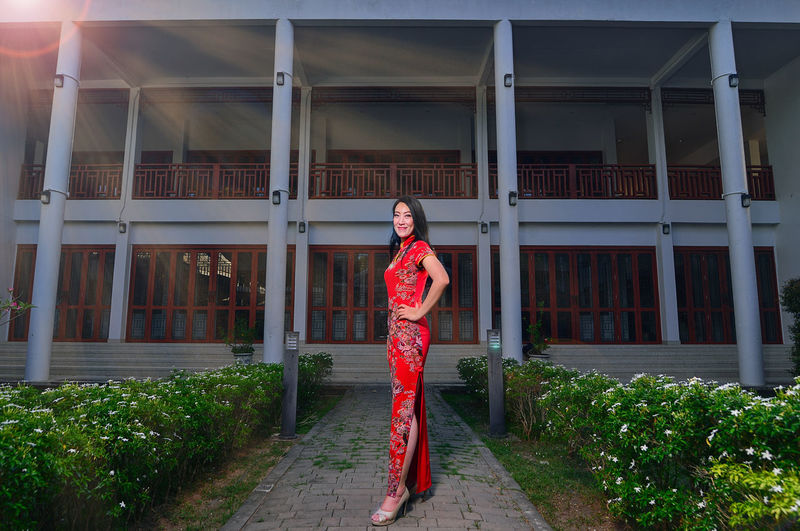 Portrait of woman standing by red structure