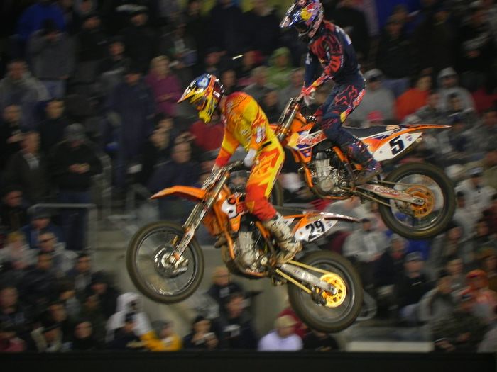 Motocross racers in mid-air at event