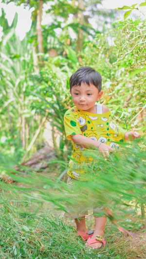 Portrait of boy smiling on field