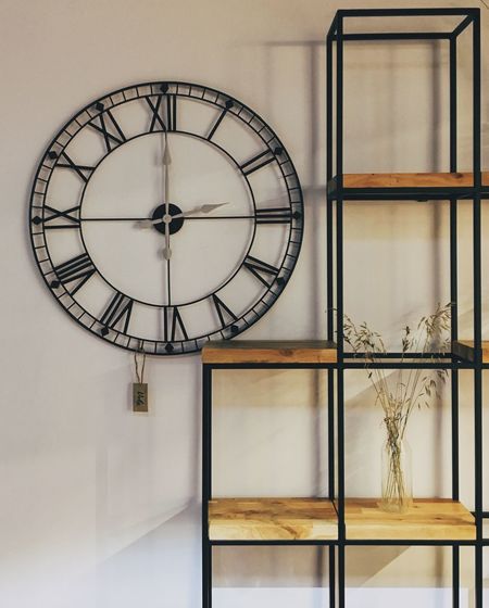 Close-up of clock against wall at home