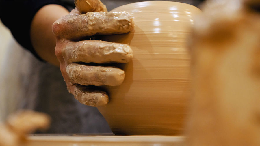 Close-up of man making pottery