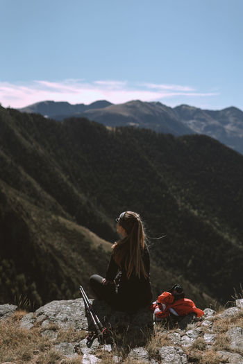 Girl in the mountains watching the landscape. hiker concept