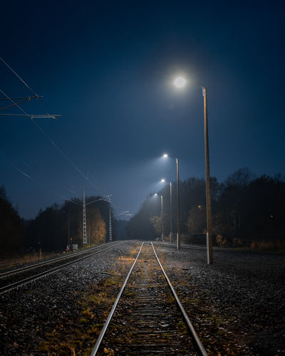 Atmospheric scene of a railroad track at night in autumn