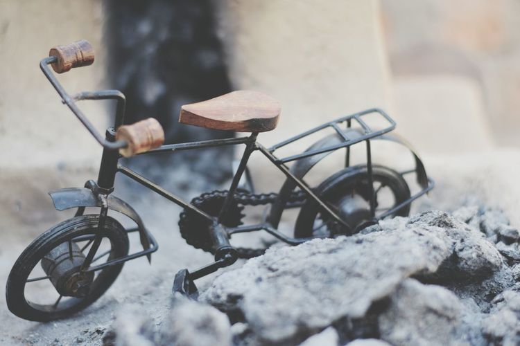 Close-up of bicycle parked on snow covered wall