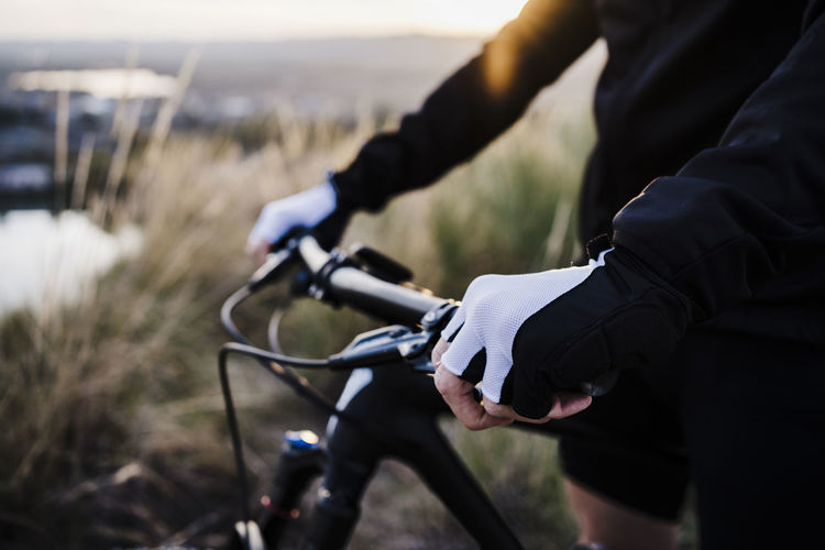 Sportsman holding bicycle