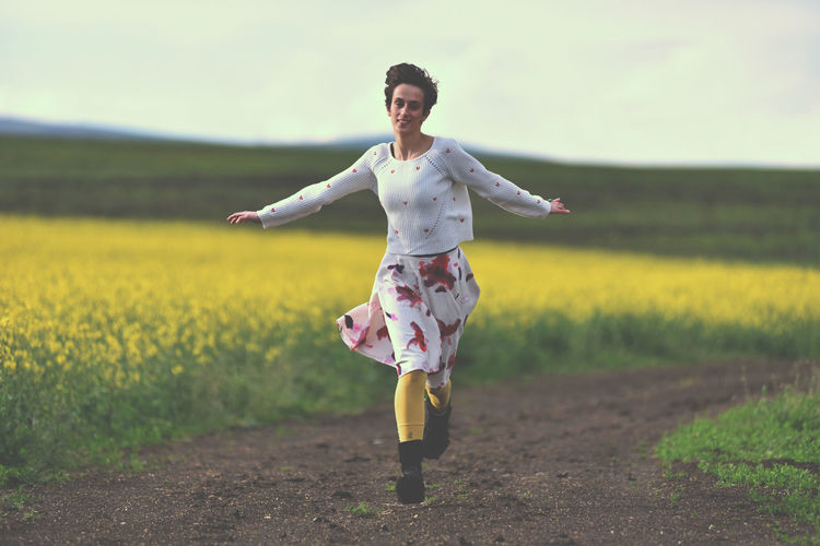Rear view of woman standing on field