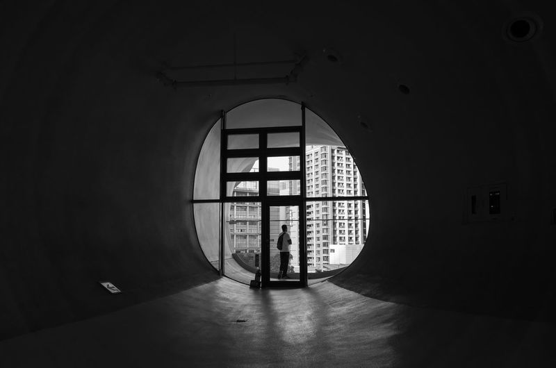 Rear view of man seen through tunnel
