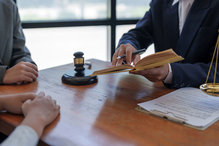 Midsection of lawyer working on table