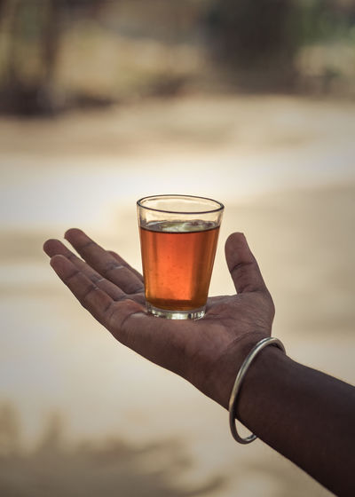 Close-up of hand holding beer glass