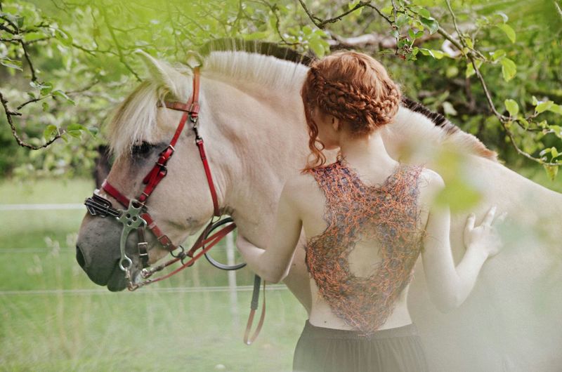 Close up of redheaded woman and horse