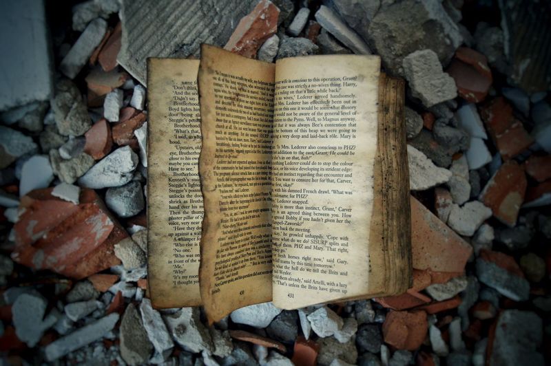 Close-up of abandoned book on ground