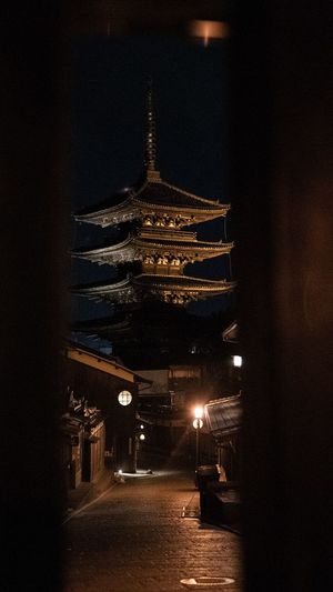 Illuminated buildings against sky at night