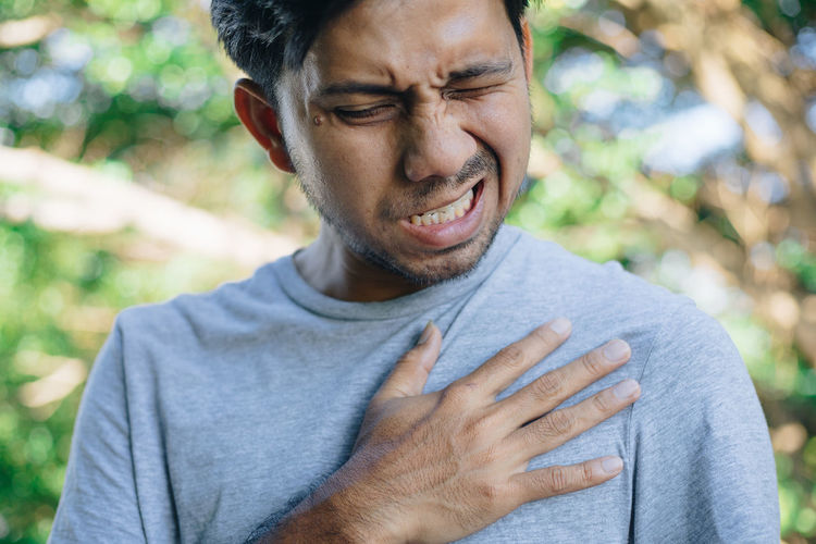 Close-up of man with heart attack outdoors
