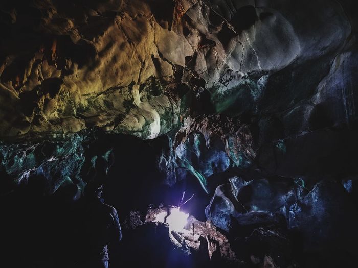 Low angle view of illuminated rock formation in cave