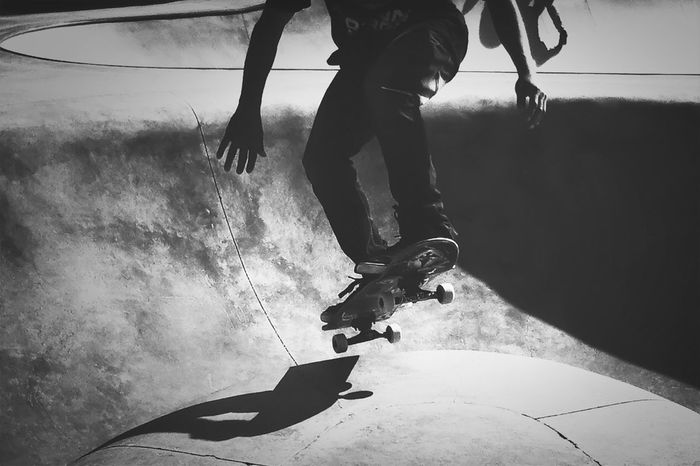 Low section of man skateboarding at skateboard park