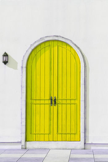 Yellow closed door of building