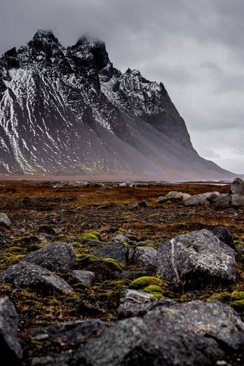 Scenic view of mountain against cloudy sky