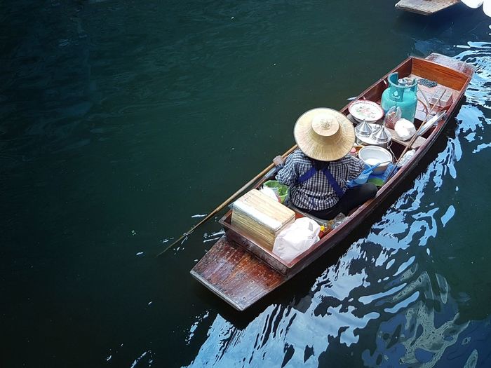 High angle view of vendor sailing in canal