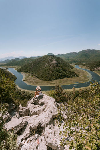 High angle view of woman sitting on rock