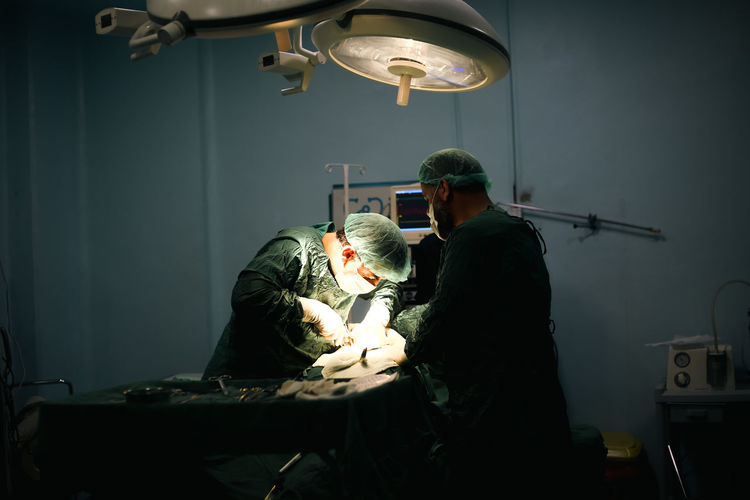 Team of surgeons doing an operation. sterile operating room.