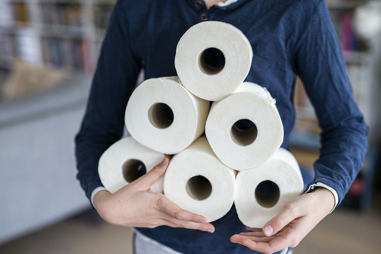 Person holding toiler paper rolls