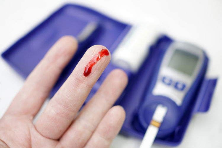 Close-up of blood drop on human finger