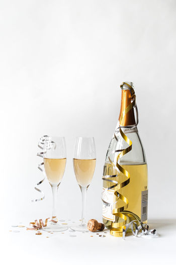 Wine bottles on table against white background