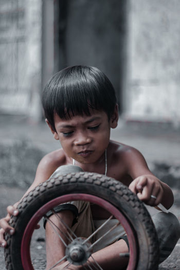 Boy playing with tire