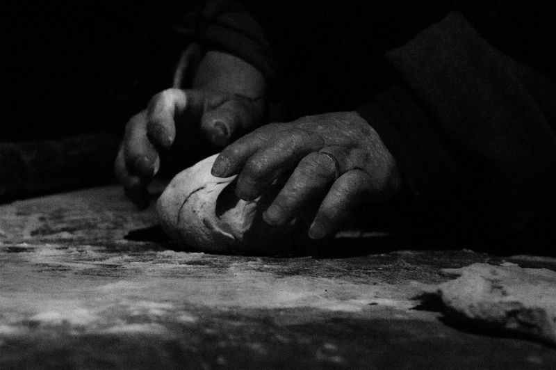 Close-up of woman working on table. presepe vivente a villa collemandina- living nativity