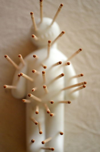 Close-up of voodoo doll on table