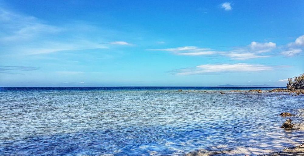 Scenic view of sea against blue sky