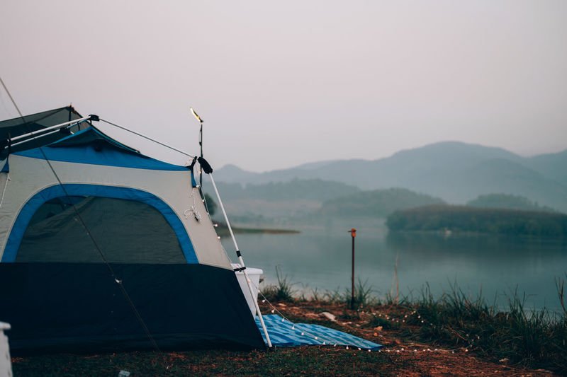 Tent in lake against clear sky