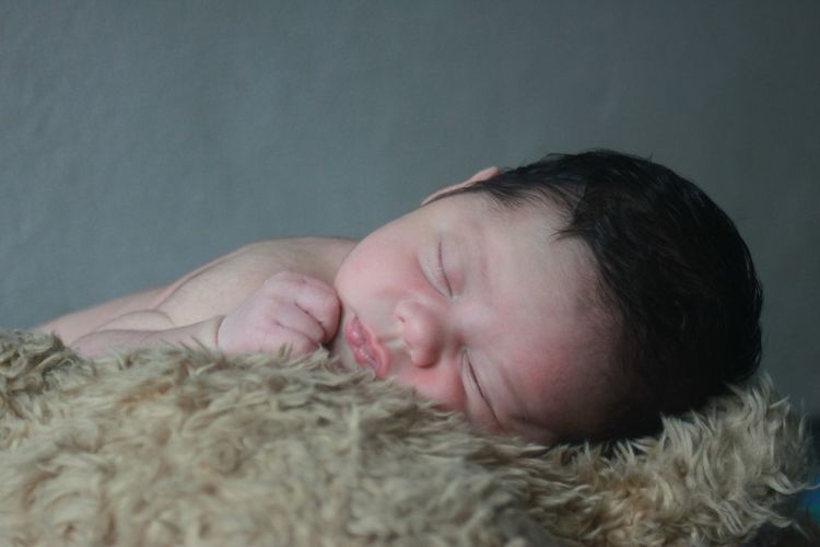 Close-up of cute baby sleeping at home