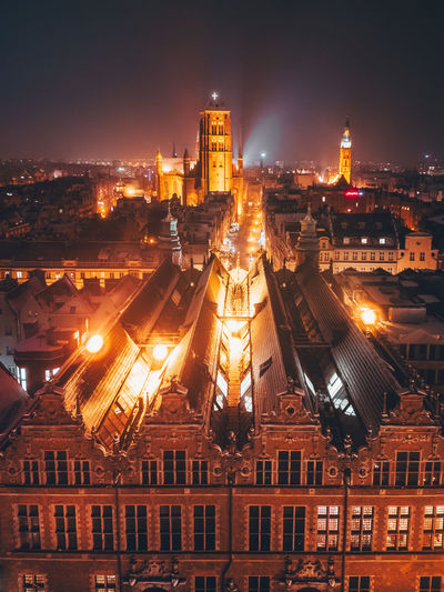 High angle view of illuminated buildings in city at night
