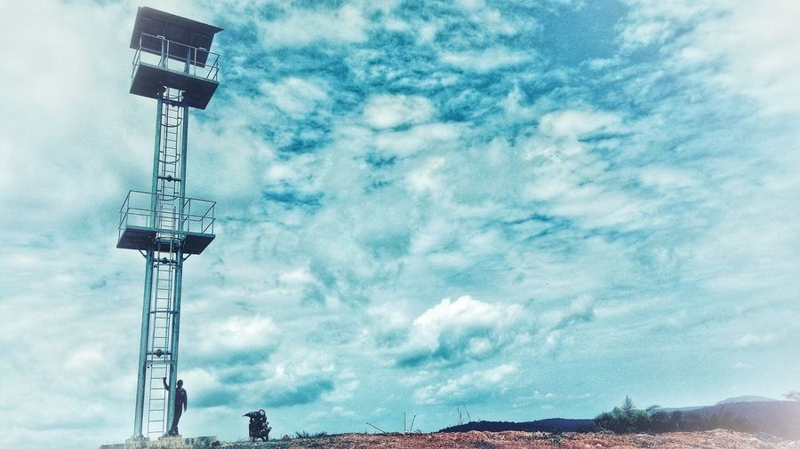 Low angle view of crane against sky