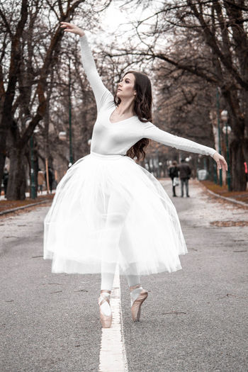 Ballerina dancing on road