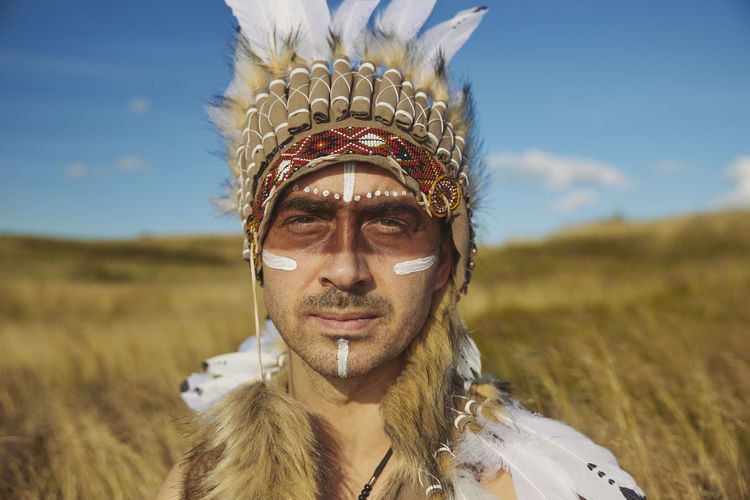 A man in traditional native american clothing in the steppe