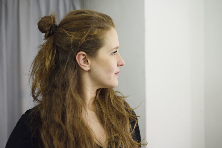 Profile view of thoughtful woman with long brown hair