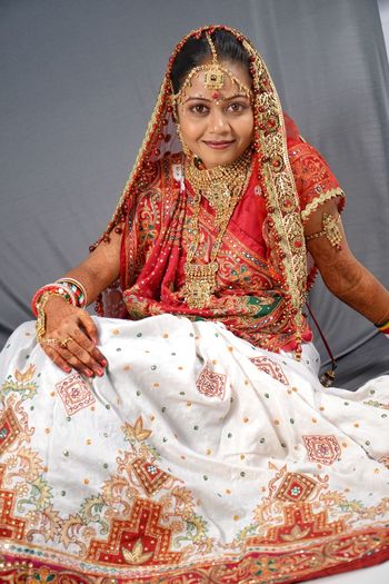Portrait of beautiful smiling young bride sitting at home