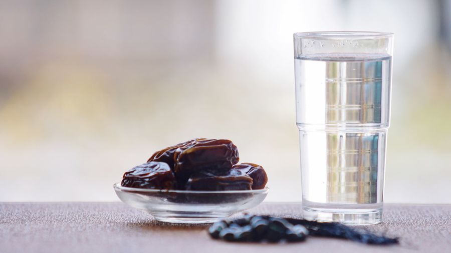 Dates and plain water for muslim breaking fast or iftar. ramadan concept